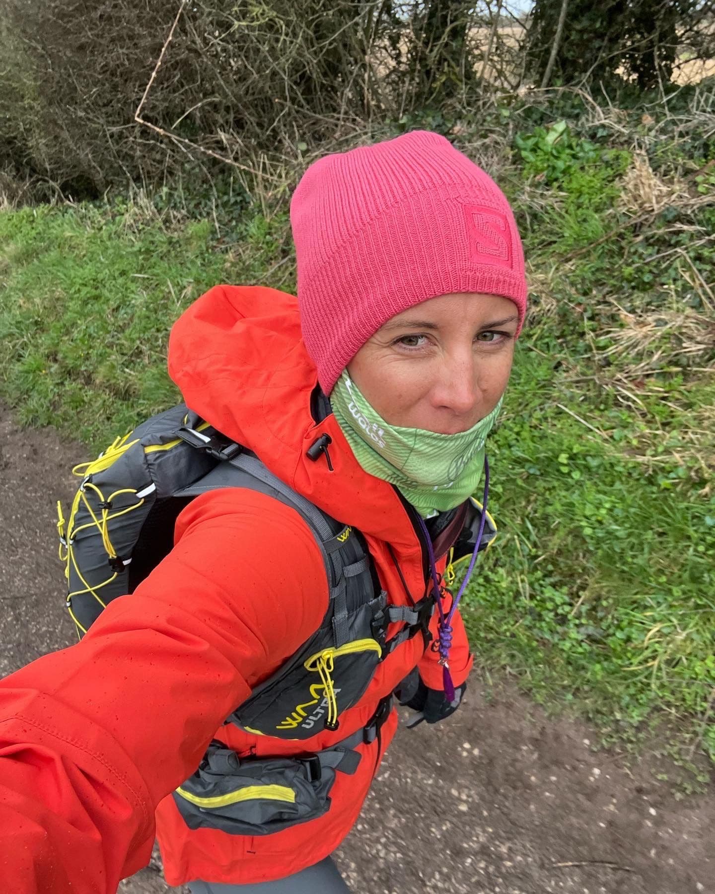 Charlotte on a cold winter training run in a pink hat with a 6kg running pack