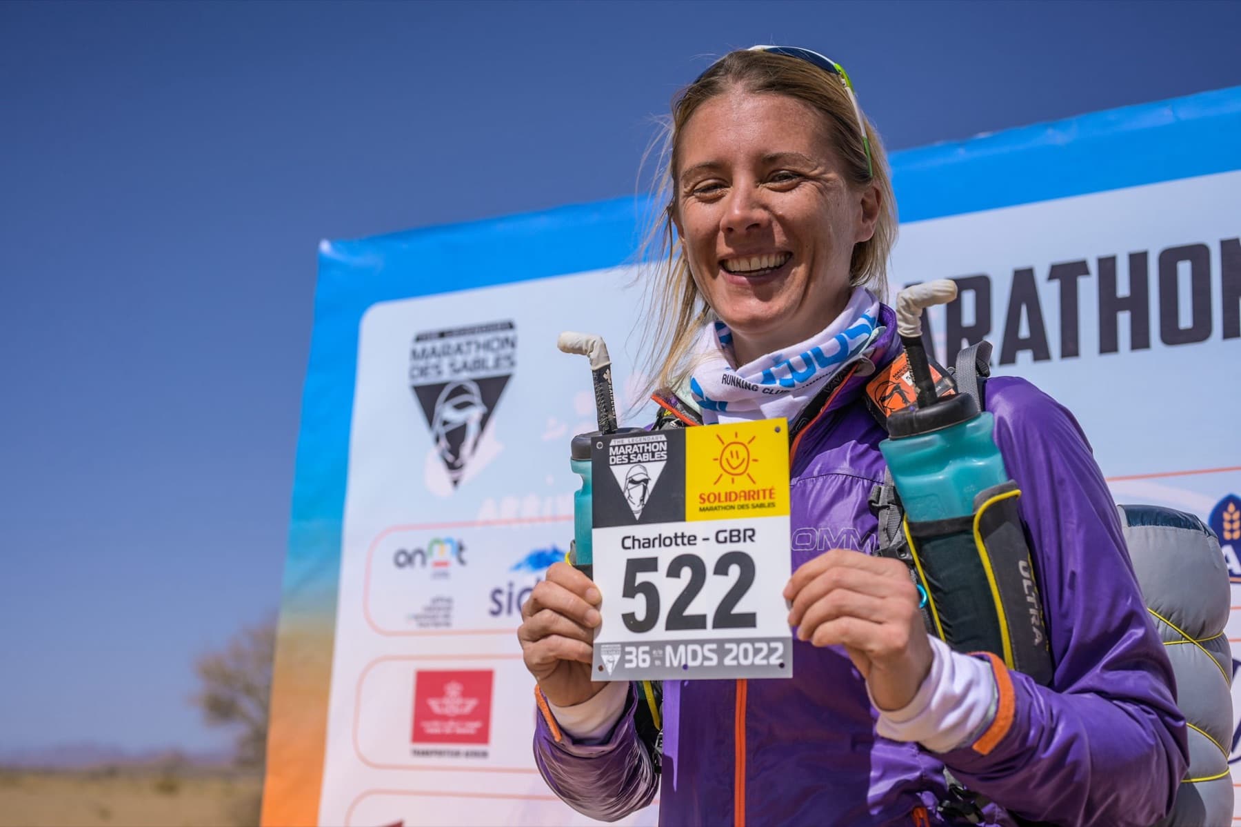 Charlotte smiling with race number 522 at the 2022 Marathon des Sables