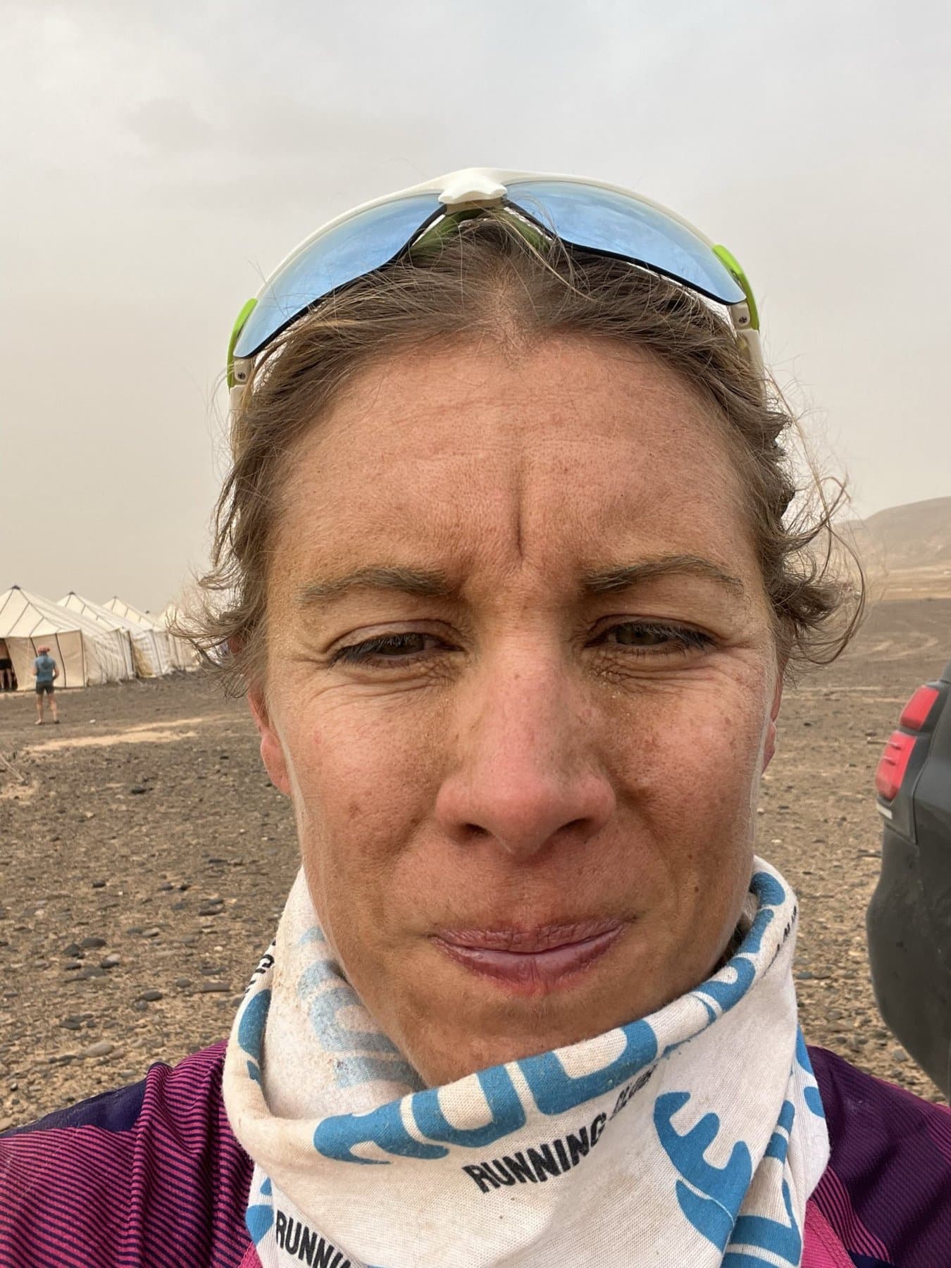 Charlotte grubby and windswept at camp after a day in the sandstorm