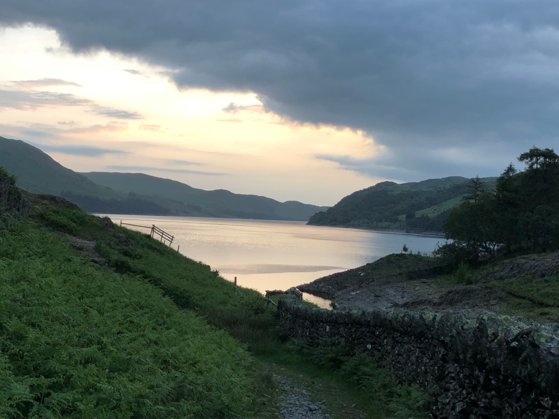Haweswater at dawn with fells under a cloudy sky