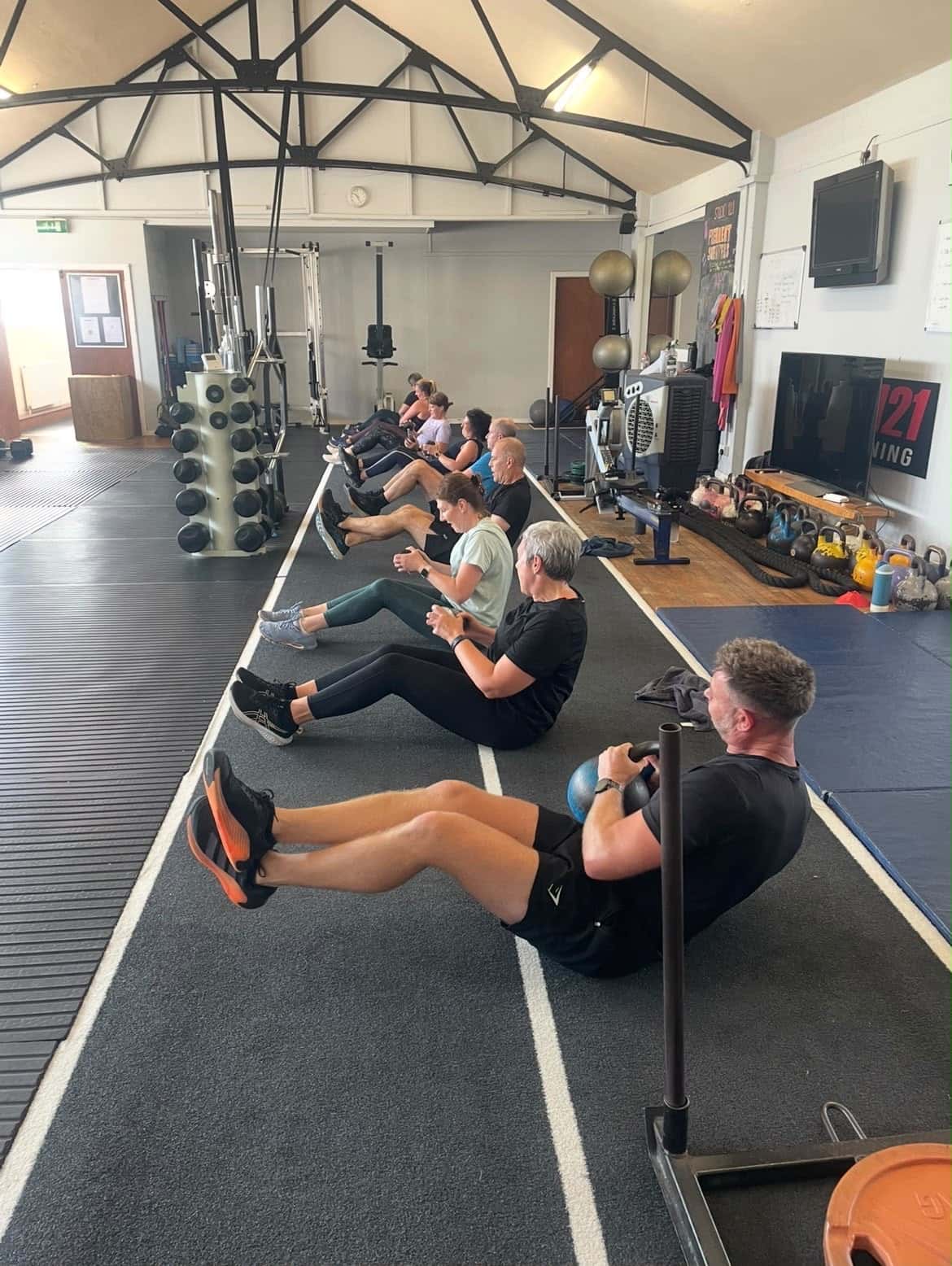 BURN class at Studio 121: clients doing seated kettlebell core work