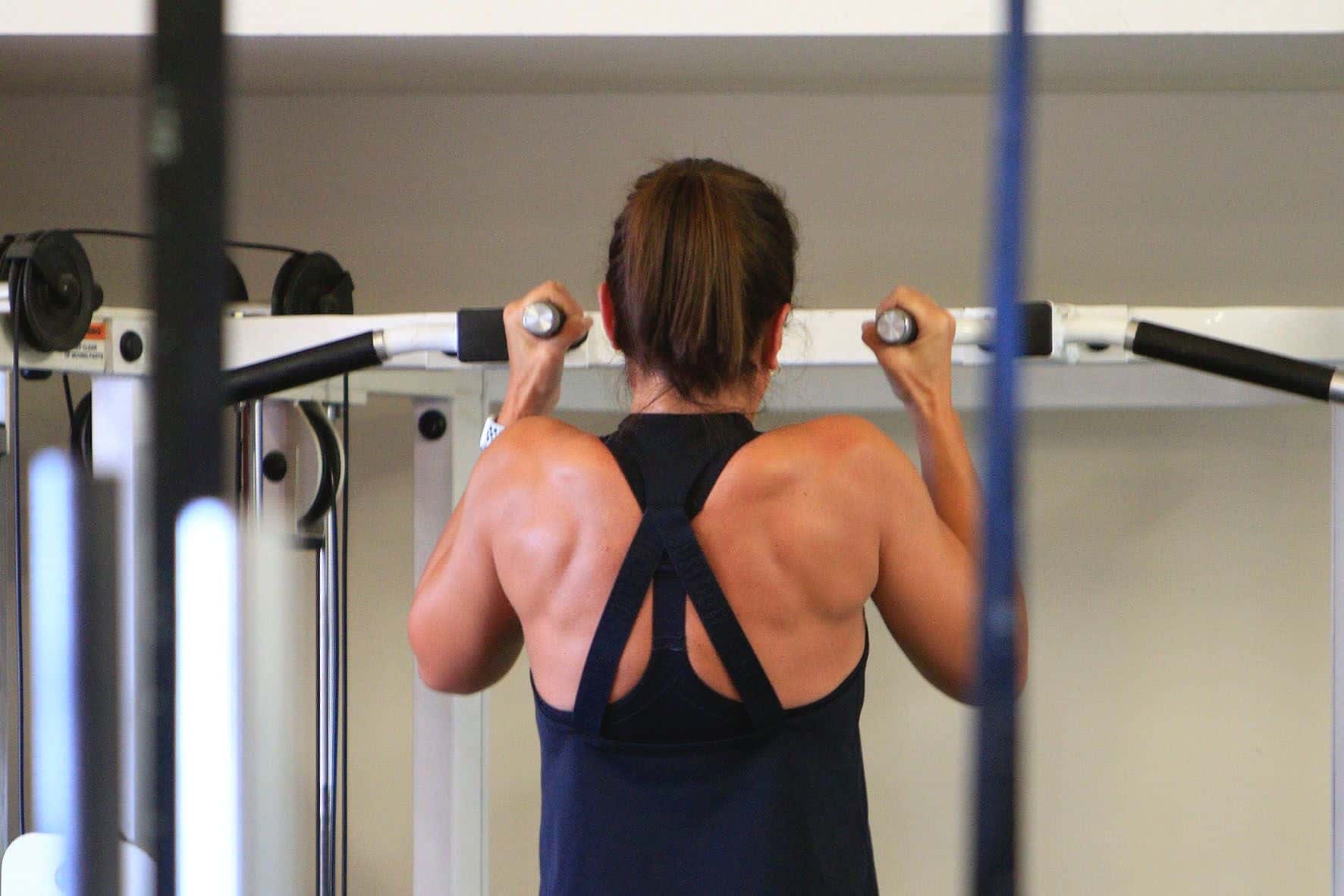 Client performing an assisted pull-up during 1-1 personal training at Studio 121