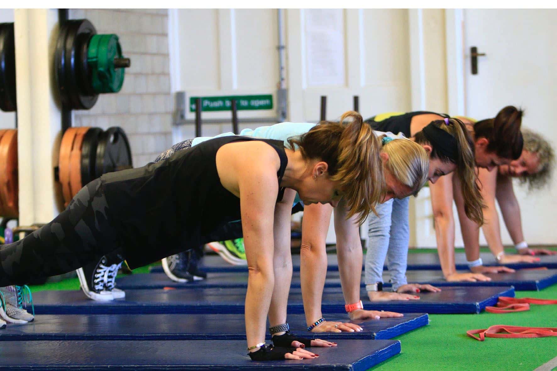 Clients holding a plank in a small group session at Studio 121
