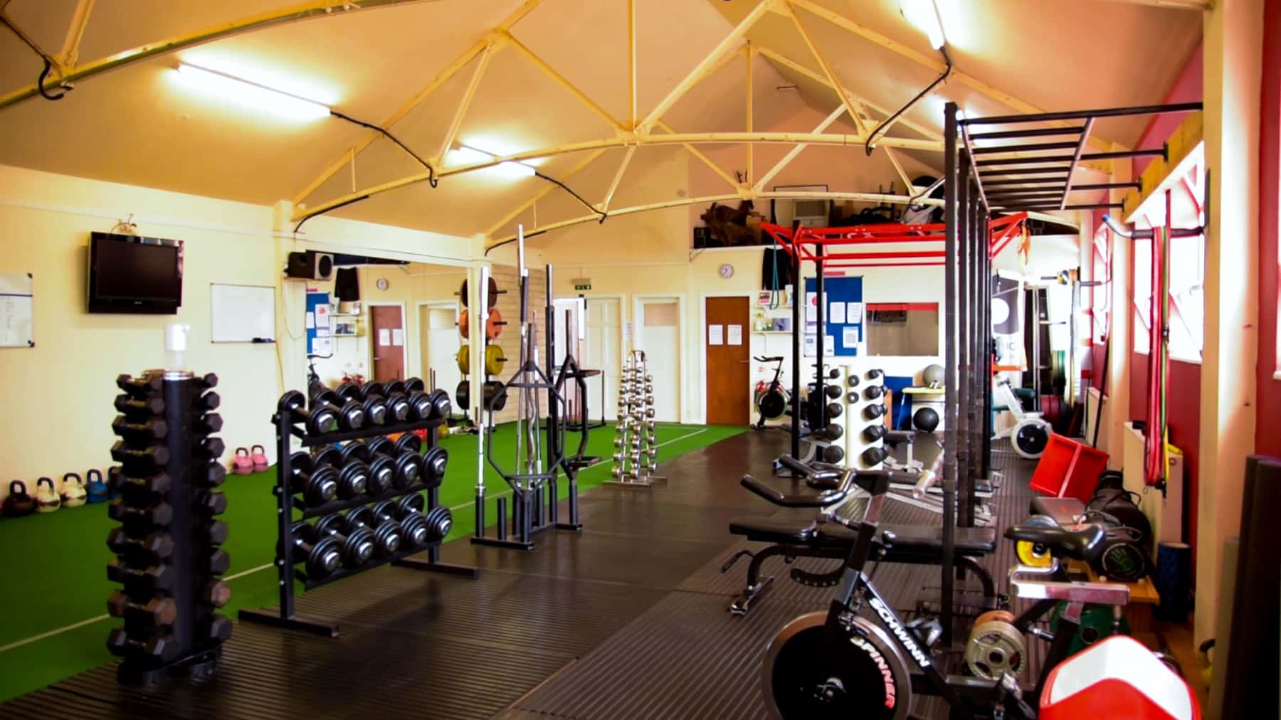 Inside Studio 121, a private personal training gym in Nantwich with dumbbell racks, barbells and turf